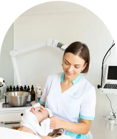 Skincare professional providing a relaxing facial treatment to a client in a professional skincare clinic.